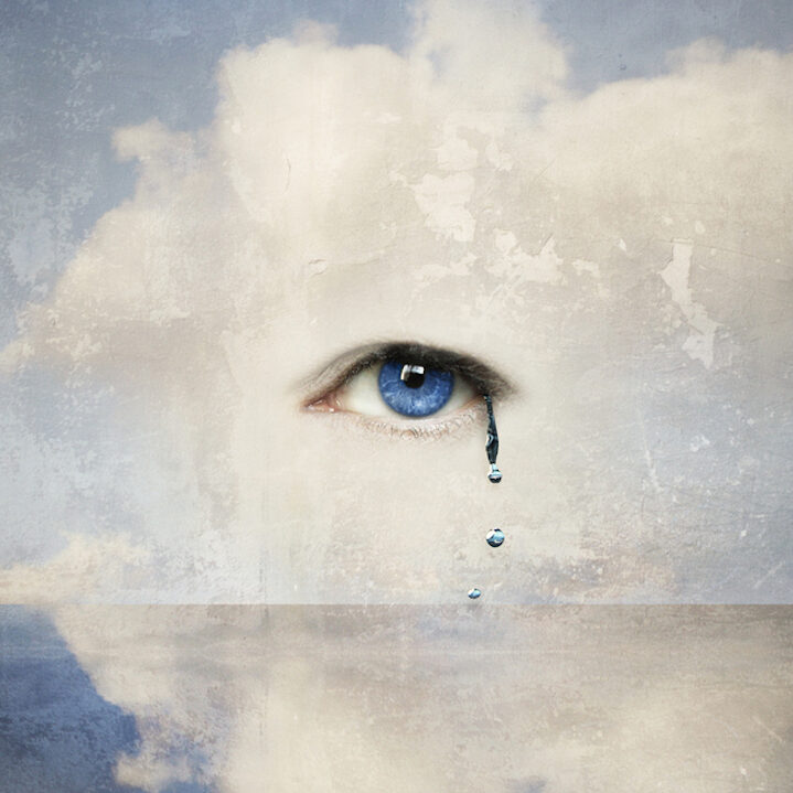 Fantasy concept of a human eye crying in the clouds